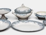several pieces of blue and white china sitting on top of a table
