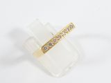 a close up of a gold ring with diamonds on a white surface