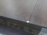 a close up of a table with a piece of wood sticking out of it