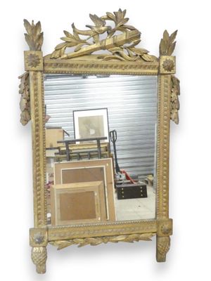 a mirror that is sitting on the wall next to a pile of boxes