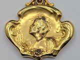 an image of a gold plated pendant with a woman ' s face