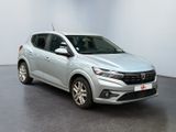 a silver car parked in a room with a white wall