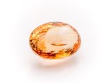 an orange sapphire stone on a white background