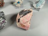 many different colored rocks on display on a table