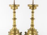 a pair of brass candlesticks with spikes on each of them