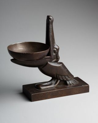 an image of a bronze bowl with a bird on it