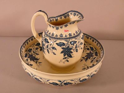 a blue and white pitcher and a plate on a table