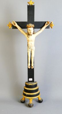 a statue of jesus on a cross on a pedestal