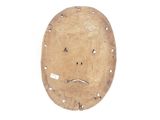 a wooden mask with a sad face on it