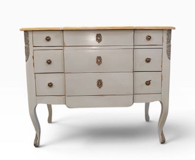 a white dresser with four drawers and a wooden top