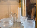 a glass display case with a lot of glass items on it