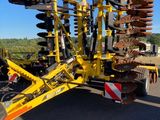 a tractor with a plow attached to the back of it