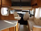 a view of the inside of a camper with couches and tables