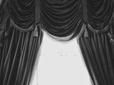 black and white photo of a bride and groom standing in front of a window