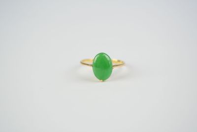 a green jade ring on a white background