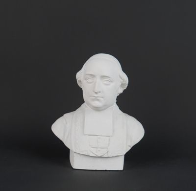 a white busturine of a man with a hat on his head