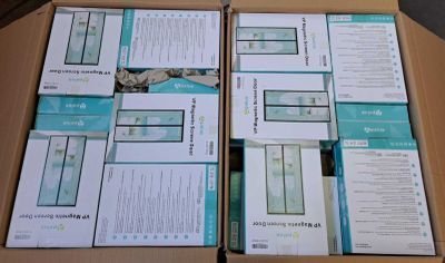 several boxes of electronic devices sitting on top of a wooden table