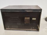 an old radio sitting on top of a table next to a lamp