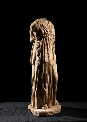 an old statue of a woman with a veil on her head
