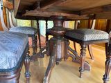 a table and chairs in a room with wood flooring