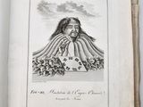 an open book with a drawing of a woman sitting on top of a table
