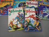 several comics are lined up in a row on a table