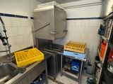 a kitchen with a sink, stove, and other items in it