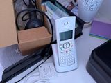 a cell phone sitting on top of a desk next to a box