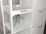 a white kitchen island with a wooden counter top