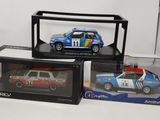 three model cars in a display case on a table