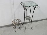 a small glass table with a metal stand next to it