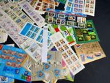 a pile of stamps and postcards sitting on a table