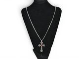 a necklace with a cross on it on a mannequin