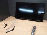 two remote controls and a television on a table