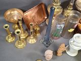 many different types of glass and brass items on the table