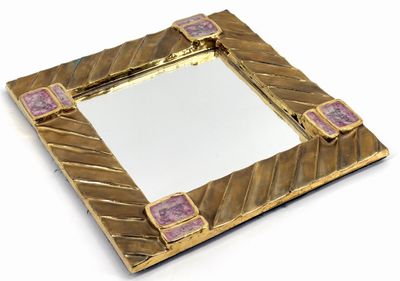 mirror with gold frame and purple tiles on top of it