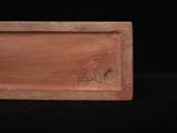 a wooden box with a bird on it sitting on a black surface