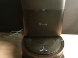 a black toilet sitting on top of a wooden table