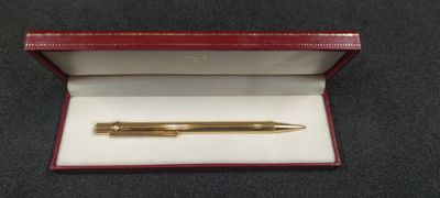 a close up of a pen in a box on a table