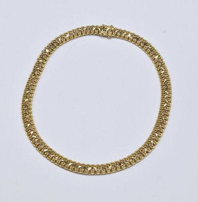 a gold chain bracelet on a white background