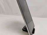 a tablet that is sitting on a stand on the table