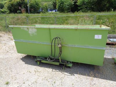 a green container with a hose attached to it