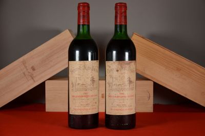 two bottles of wine sitting on top of a table next to a wooden box