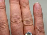 a woman ' s hand with a ring on it