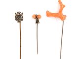 three different types of pins on a white surface