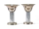 pair of silver candlesticks with fluted bases on a white background