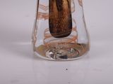 a glass vase with a banana in it on a table