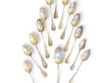 a lot of spoons arranged in a circle on a white surface