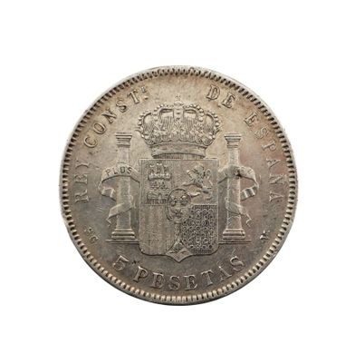 une vieille pièce d'argent sur laquelle figurent des armoiries et une couronne