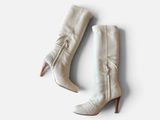 the white boots are on a white surface with a white background